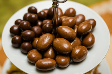 Nuts in dark and milk chocolate on a plate.