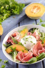 melon slice with prosciutto ham and mozzarella