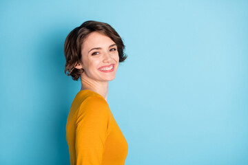 Fototapeta premium Profile portrait of nice optimistic brunette lady wear yellow shirt isolated in vivid blue color background