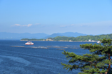 瀬戸内海に浮かぶ牡蠣筏とフェリー