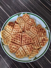 Ruddy waffles on a platter. Fresh bakery.
