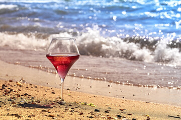 Wine glass with a cocktail by the sea.