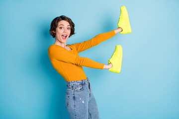 Profile photo of impressed nice brunette short hairdo lady show sneakers wear brown shirt isolated...