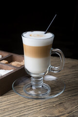 Coffee latte served in a transparent glass