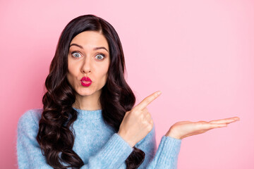 Obraz premium Photo of adorable person kiss lips indicate finger empty space arm palm isolated on pink color background