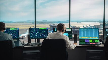 Diverse Air Traffic Control Team Working in a Modern Airport Tower. Office Room is Full of Desktop Computer Displays with Navigation Screens, Airplane Departure and Arrival Data for Controllers. © Gorodenkoff