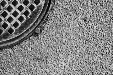 Old manhole cover in asphalt. View from above