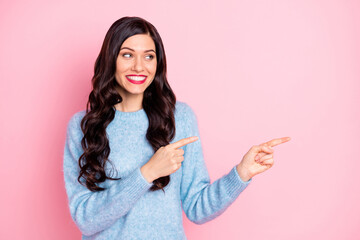 Portrait of pretty positive girl look indicate fingers empty space proposition isolated on pink color background