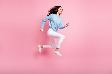 Fototapeta na wymiar Full length profile photo of funny girl jump run fast wear blue pullover isolated pink color background