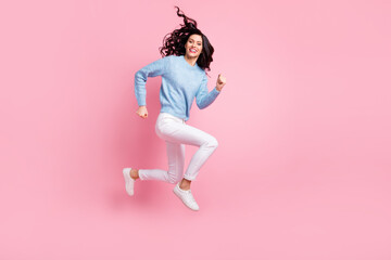 Full length profile photo of crazy energetic girl jump run look camera wear blue sweater isolated...