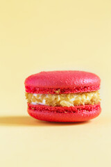 red Cake macaron or macaroon on yellow background.