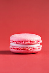 pink Cake macaron or macaroon on red background.