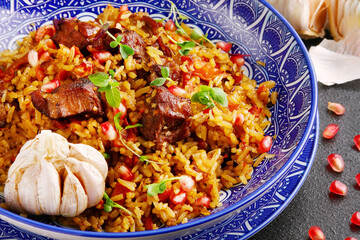 Pilaf and ingredients on plate. National Uzbek pilaf with meat