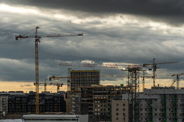Cranes over construction site for apartment buildings, Helsinki Finland - 434954840