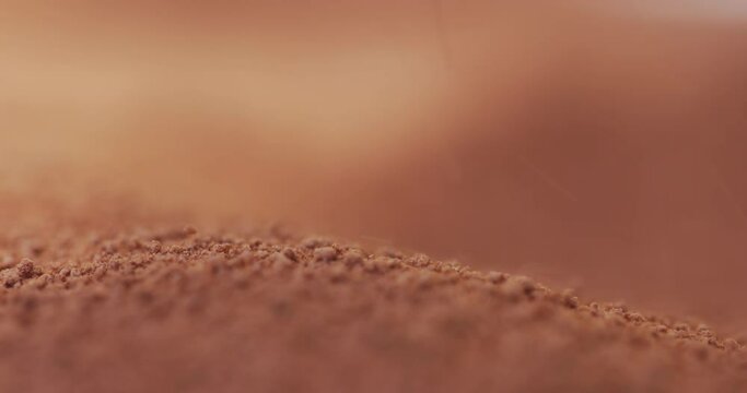 Powder flowing as sand like object closeup 