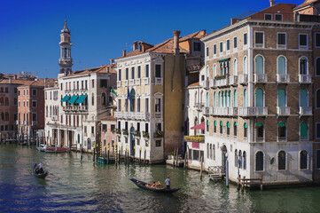 Naklejka premium facades facing blue clean waters of busy grand canal of Venice