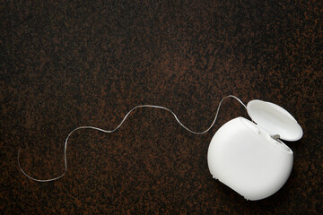 Dental floss on a dark background with copy space