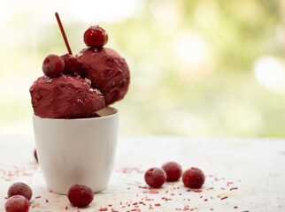 red cherry ice cream  on white background. Organic Berry Sorbet Ice Cream Balls in Cup Ready to Eat. Ice Cream Cherry in the ceramic cup