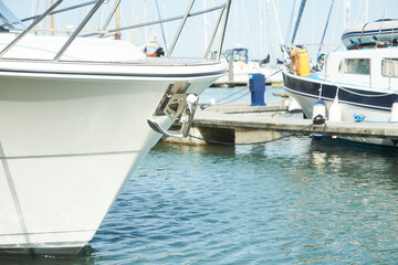 Fototapeta premium Yacht anchor close-up seen on the front of a large boat. Sailboat bow parked in harbor, yachting, sailing