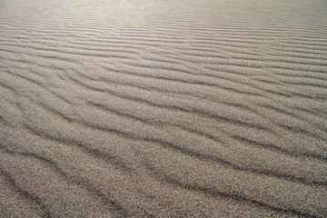 wind blowing sand into ripples