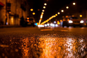 Nights lights of the big city, the main city street in rushhour. Close up view from the level of...