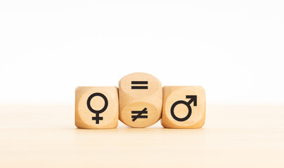 Gender equality concept. Wooden block turning a unequal sign to a equal sign between symbols of men and women. Copy space - obrazy, fototapety, plakaty