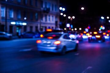 Nights lights of the big city, the city street with cars riding on it. Defocused image