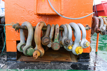 Big steel shackles on offshore supply vessel. Towing equipment.
