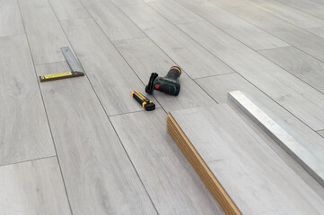 Laying laminate floor with tools. Nobody, empty room. Finished process 