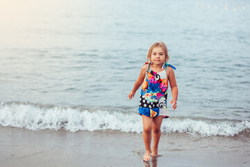 Fototapeta na wymiar Adorable cute little girl portrait on the beach. Childhood, vacation concept