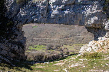 Flowers in spring, and natural stone arch in northern Spain