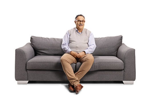 Mature man sitting on a sofa and smiling at camera