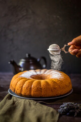 When pouring powdered sugar on the cake