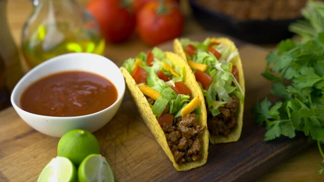 hard shell taco on wooden board with lime