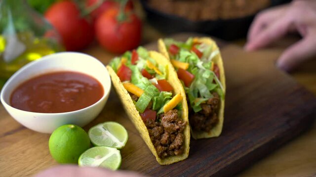hard shell taco on wooden board with lime