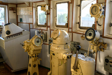 Navigational bridge on abandoned vessel. Old derelict ship wheelhouse. Ship's control device....