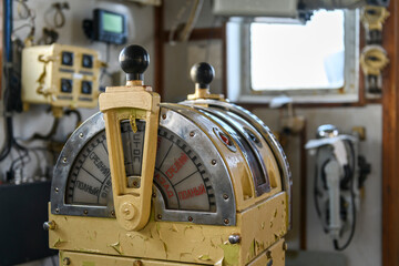 Navigational bridge on abandoned vessel. Old derelict ship wheelhouse. Ship's control device. Russian words: Ahead/Astern, full, half, slow, dead slow, stop, stand by. © Alexey Seafarer