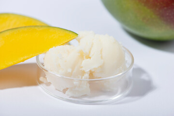 Mango butter and fresh mango fruit. Organic cosmetic, skin care, spa concept.