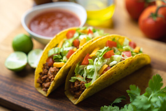 hard shell taco on wooden board with lime