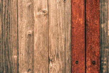 Old wooden gate with rusty iron insert. View close up