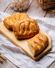 Side view on fresh baked puffs with cheese filling