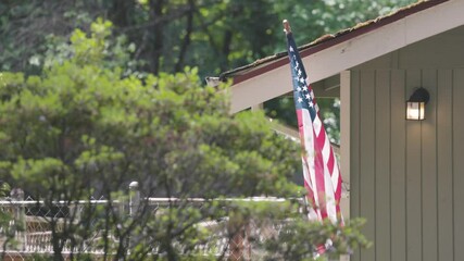 american flag flying outside a home in rural usa - Powered by Adobe