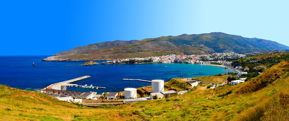 Fototapeta na wymiar Panoramic view of the harbour and Nemporio beach in the old town of Chora in Andros, famous Cycladic island in the heart of the Aegean Sea