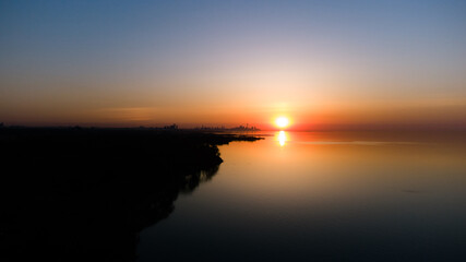Fototapeta premium Golden Hour Sunrise sunset on the lake with orange sky 