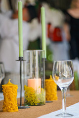 custom candles with empty glasses on a wedding table, minimal concept