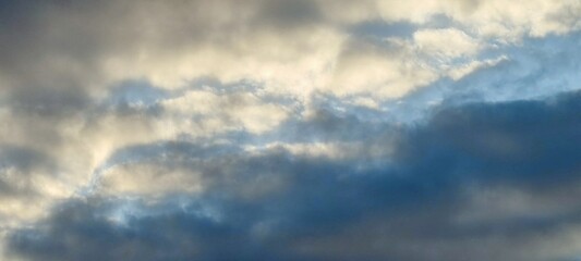 White and light gray clouds on the blue sky. On a clear sunny day, there are several high cumulus...