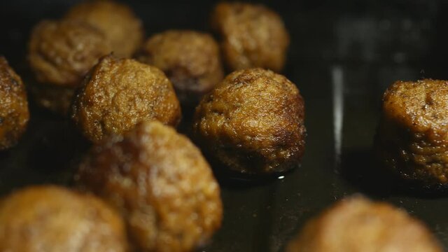 fried meatballs on a metal baking sheet. Filming Dolly.