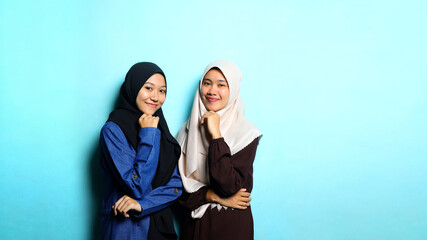 Portrait of young beautiful woman with blue background for copy space.