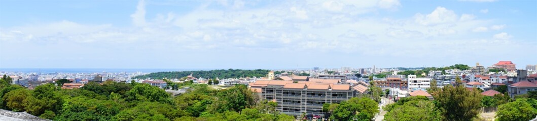 Fototapeta na wymiar Aerial view of Naha city and sea shore from Shurijo castle in Okinawa, japan. Panorama - 沖縄 那覇市の街並みと海