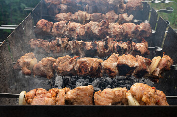 Meat strung on skewers is cooked on the grill